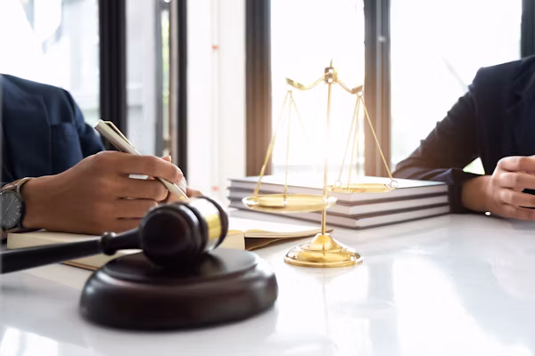 A gavel resting beside the scales of justice